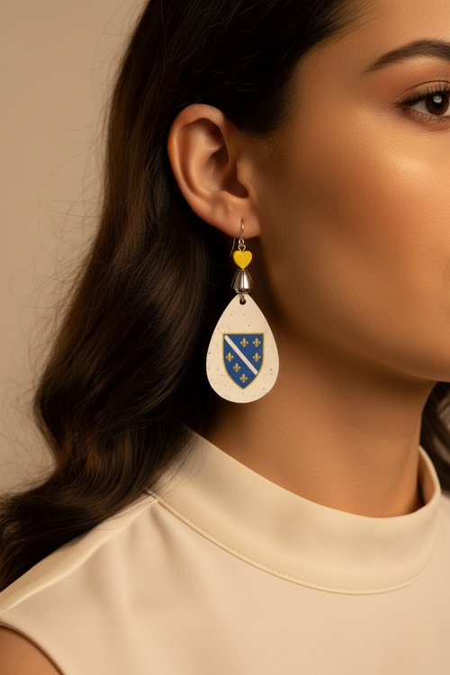 Close-up of Bosnia fleur-de-lis shield earrings being worn