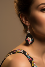 Close-up of roller skate earrings being worn