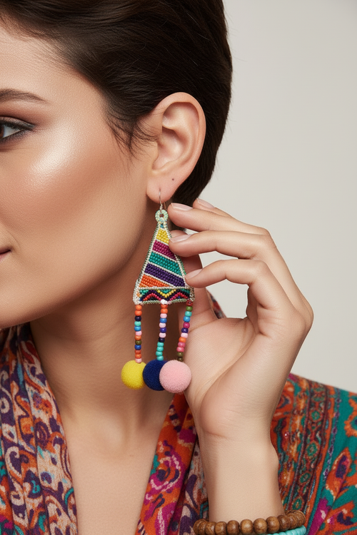 Extreme close-up of rainbow pom-pom earrings