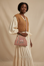 Model wearing paisley crossbody bag, no flowers in hair
